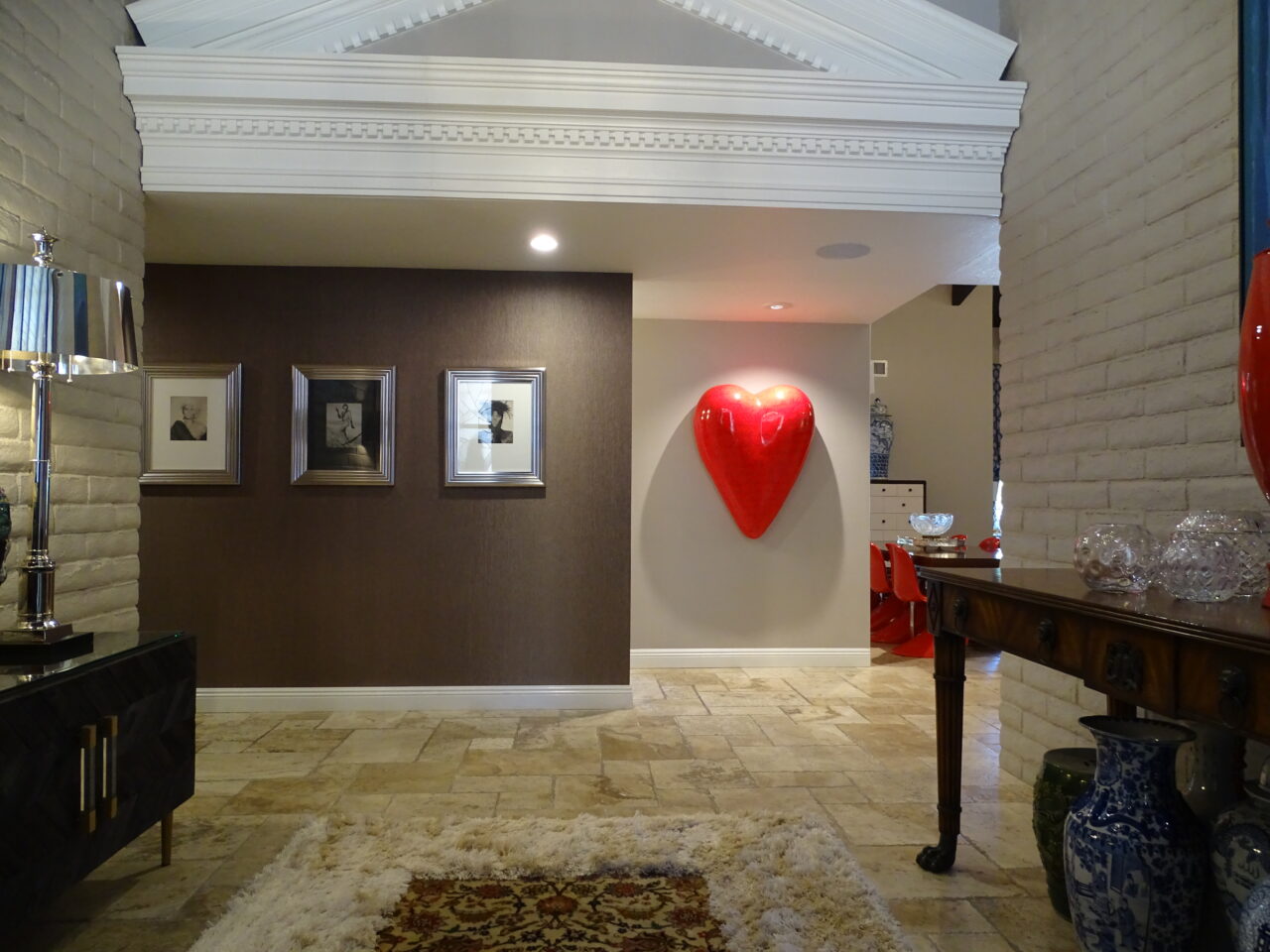 Elegant home interior with large red heart sculpture.