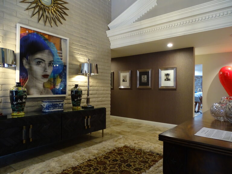 Elegant lobby with artistic decor and colorful portrait.