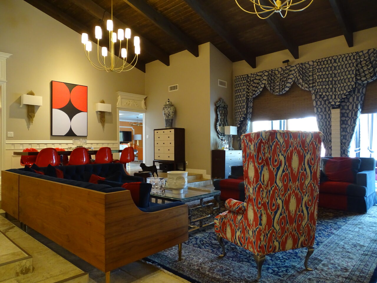 Elegant living room with bold red chairs and art.