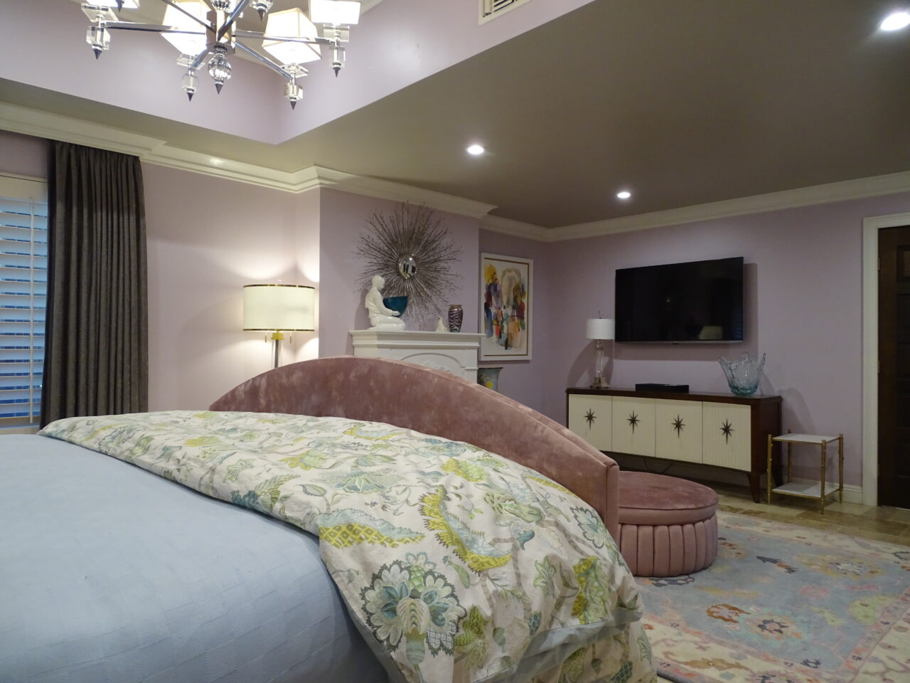 Elegant bedroom with lavender walls and stylish decor.