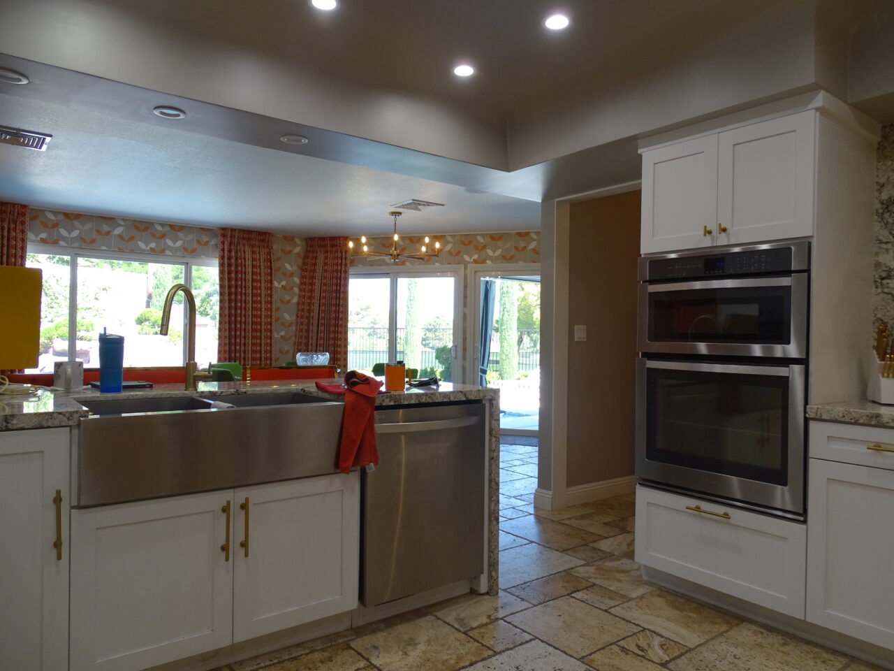 Modern kitchen with stainless steel appliances and white cabinets.