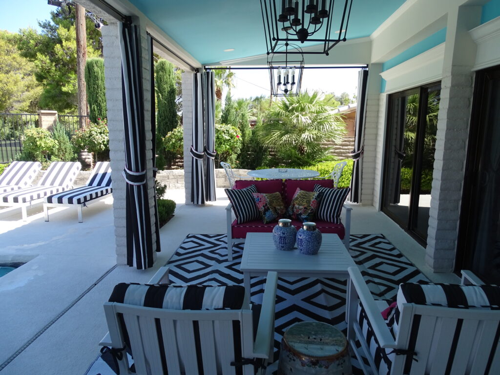 Elegant outdoor patio with seating and pool view.