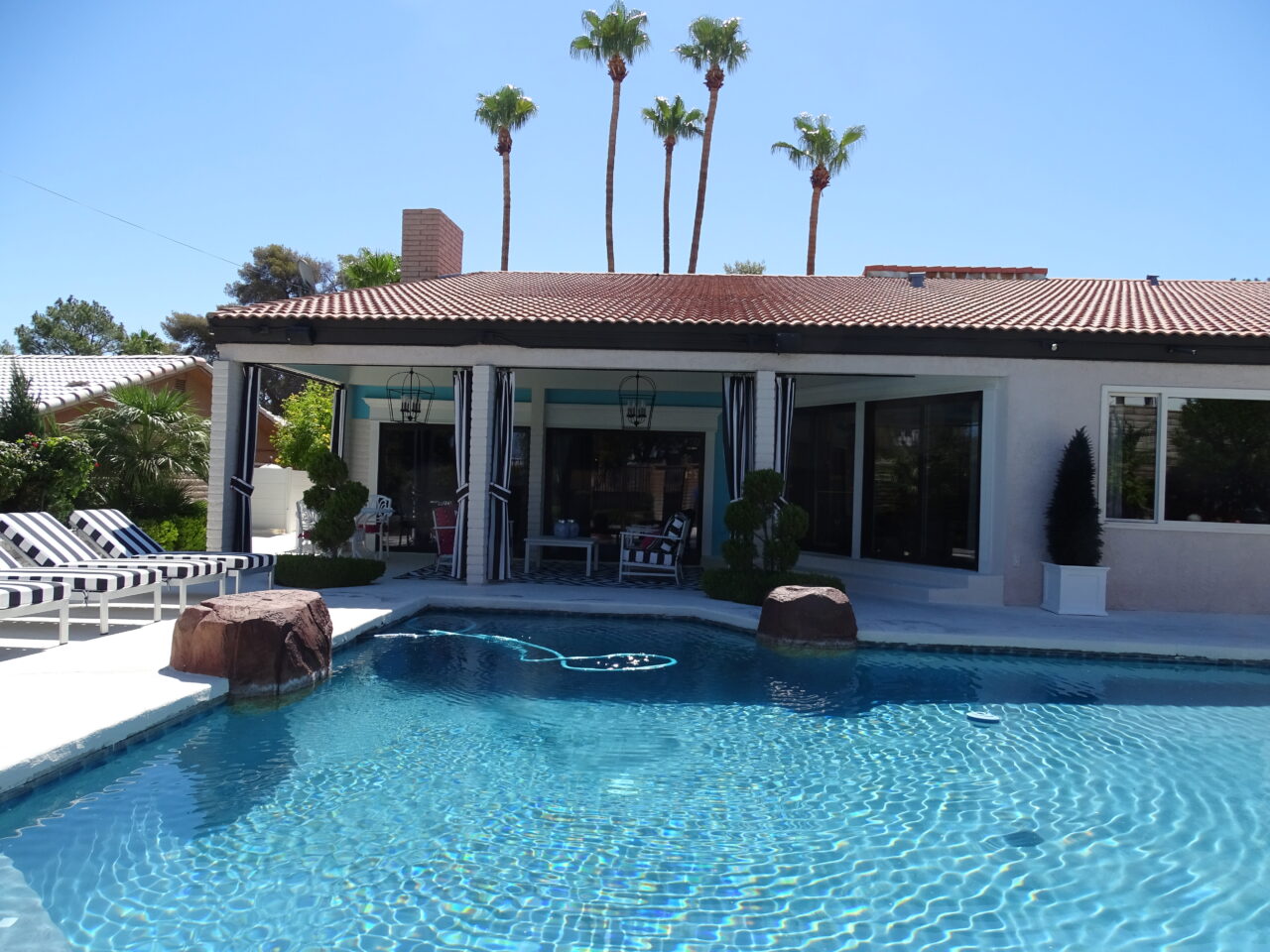 Luxury home with pool and palm trees