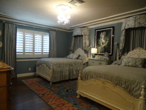 Elegant vintage bedroom with twin beds and decorative accents.