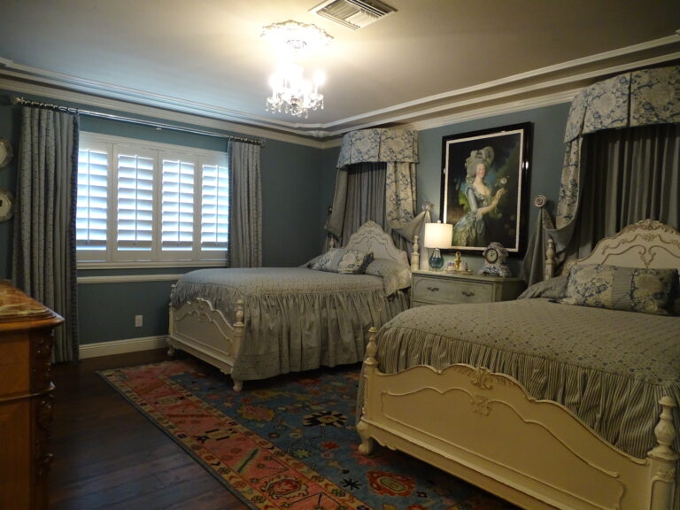 Elegant vintage bedroom with twin beds and decorative accents.