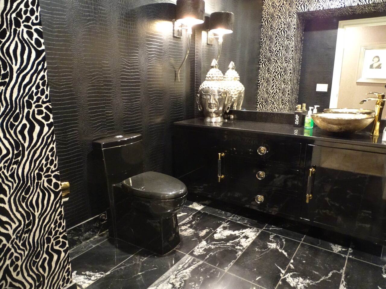 Luxurious black marble bathroom with ornate décor.