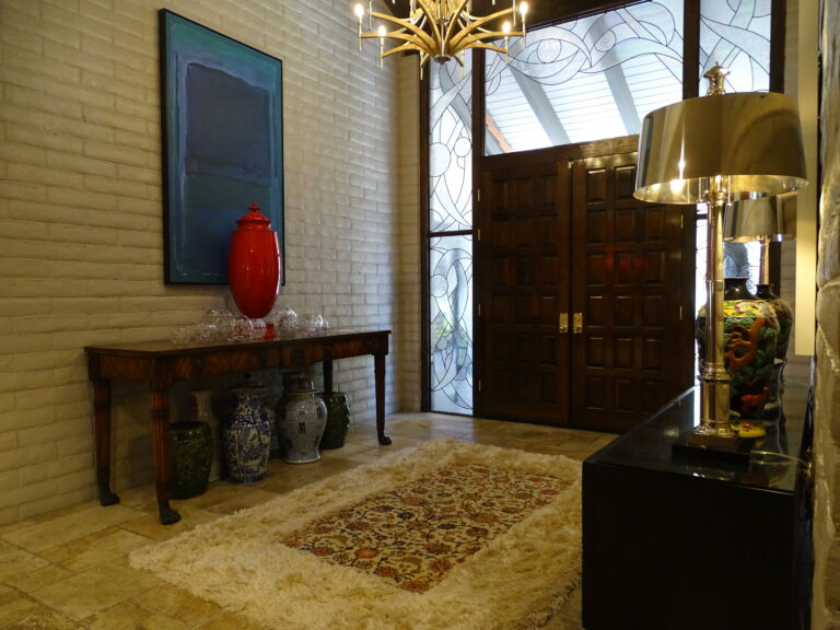 Elegant foyer with decorative vases and artistic stained glass.