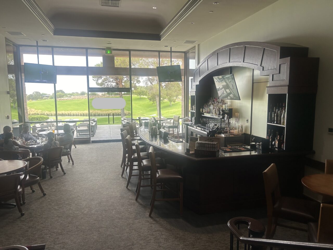 Spacious bar interior overlooking green golf course