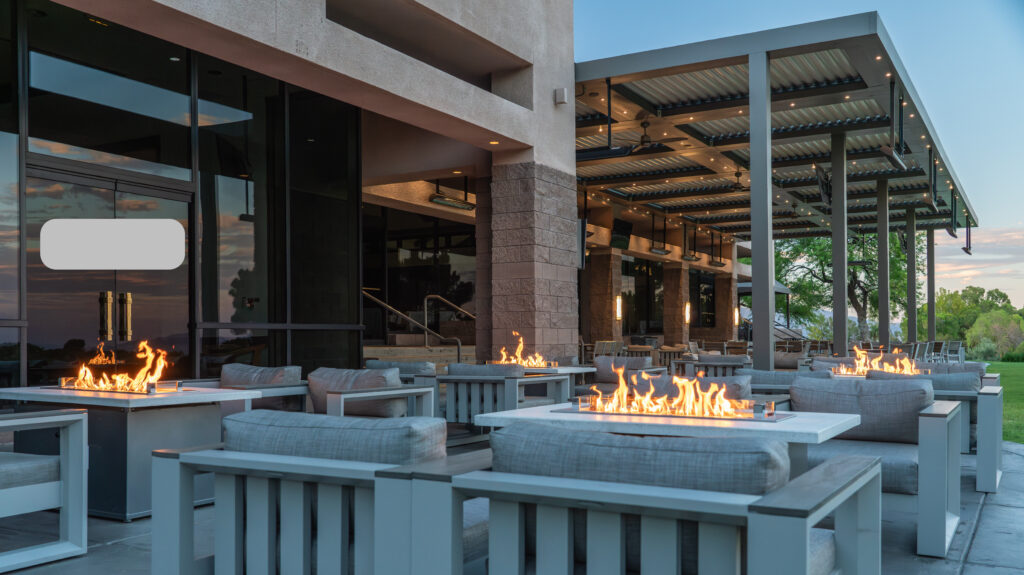 Outdoor patio with fire pits and modern seating at dusk