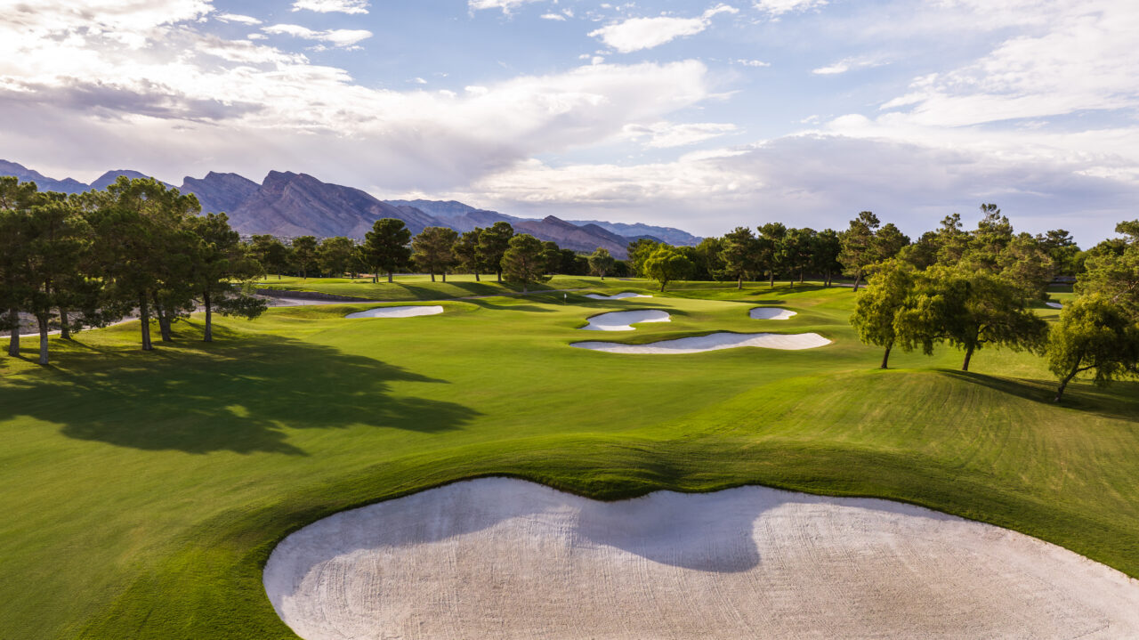 Scenic golf course with mountains and sand traps