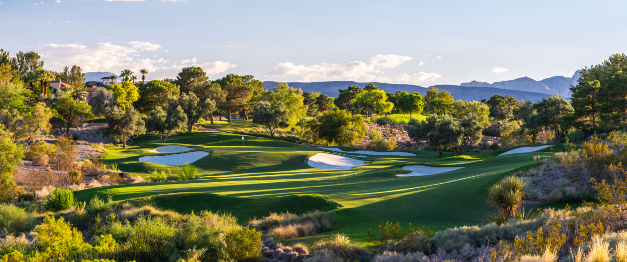 Scenic golf course with rolling greens and mountains