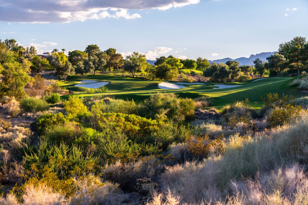 Scenic desert golf course with mountains in background