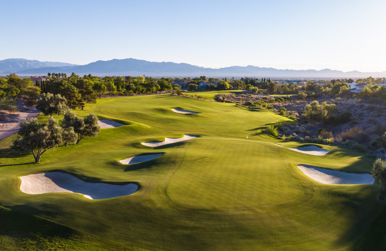 Scenic golf course with lush greens and mountain backdrop