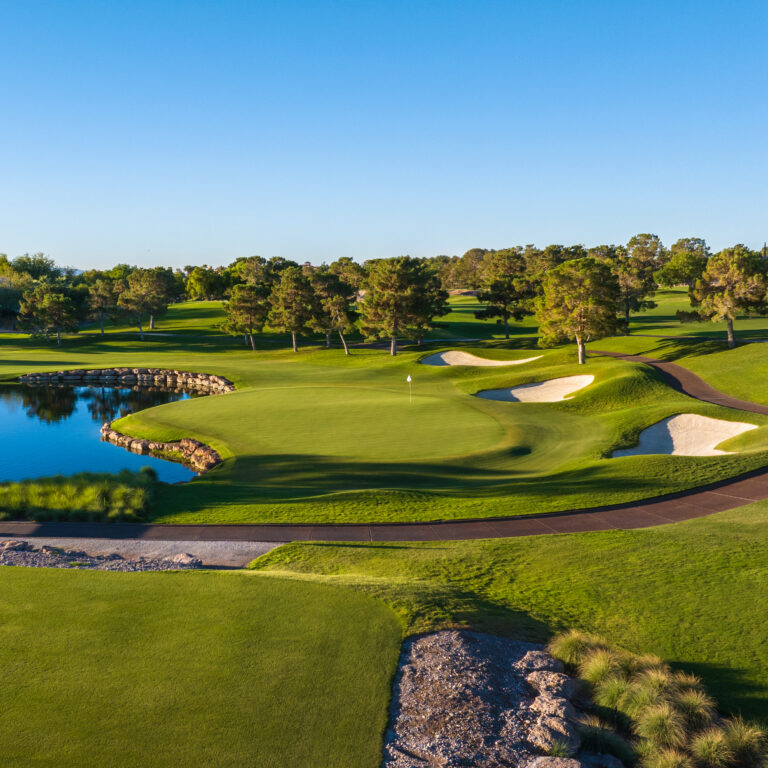 Scenic golf course with lush greens and water hazard