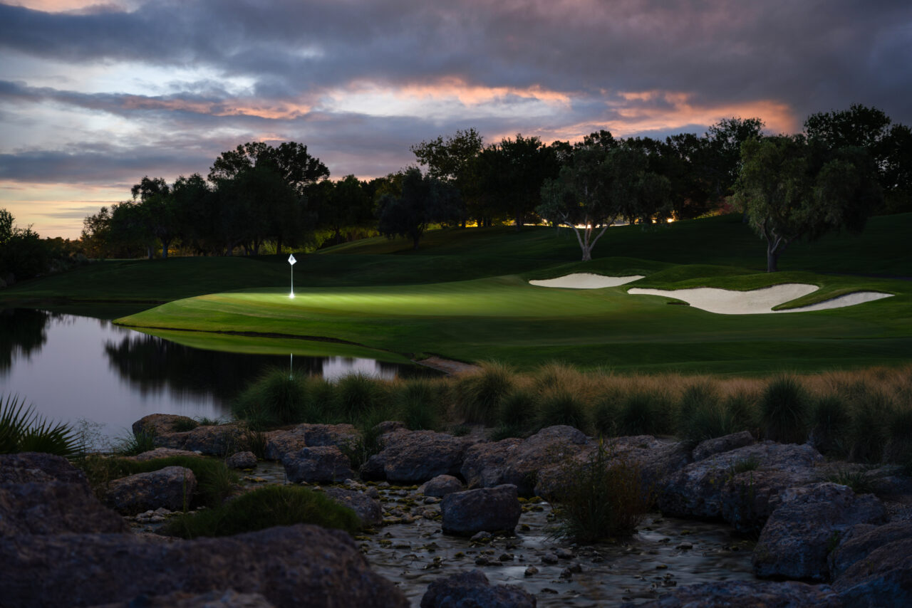 Scenic sunset over tranquil golf course with pond