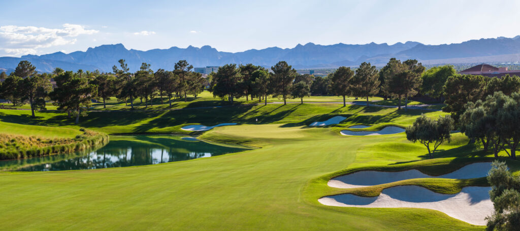 Scenic golf course with ponds and mountain backdrop