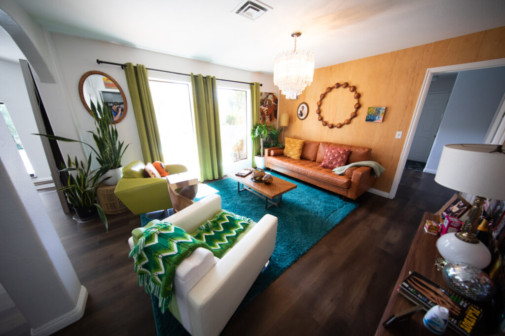 Bright living room with retro decor and turquoise rug