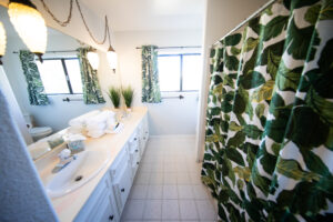 Bright bathroom with tropical-themed decor and double vanity