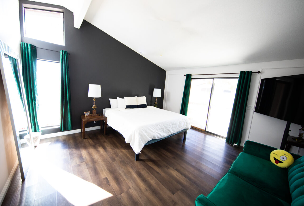 Modern bedroom with white bed and green curtains