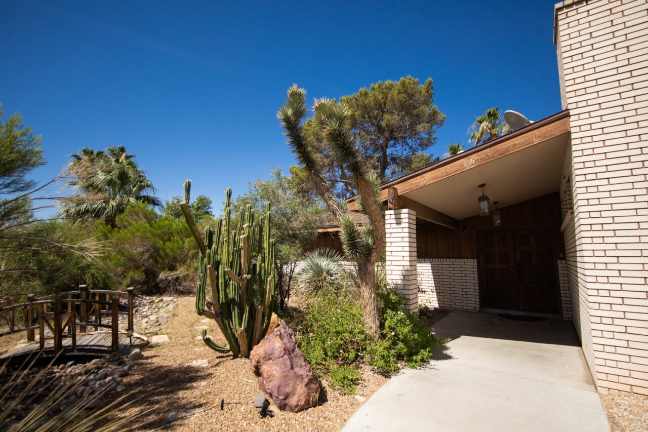 Desert home with cacti and clear blue sky